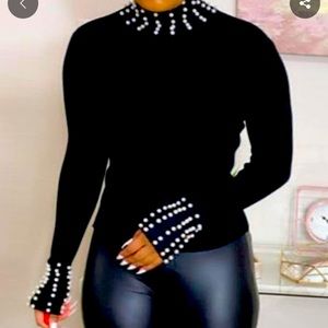 Medium (runs small), beautiful pearl studded turtleneck. Pearls-neck and sleeve